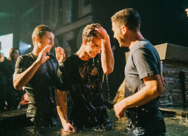 Friends celebrating after a baptism in the water