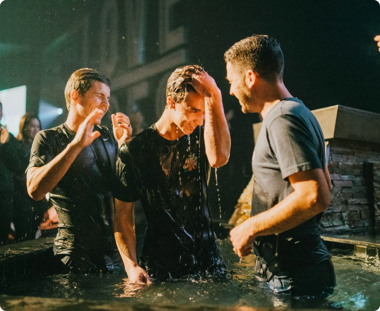 Friends celebrating after a baptism in the water